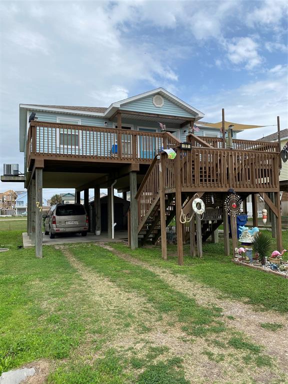 a view of a house with a yard and sitting area