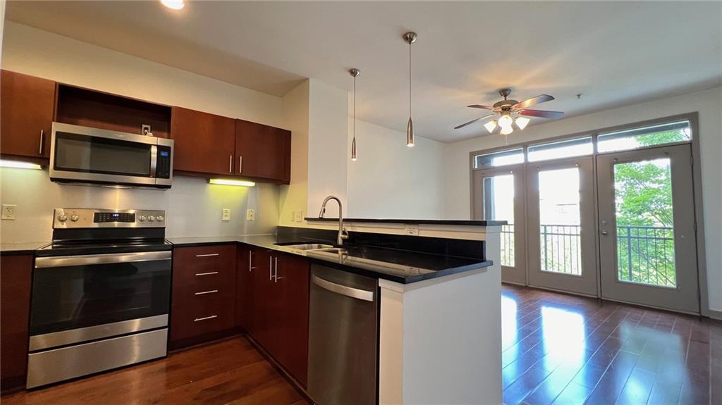 a kitchen with a sink stove and microwave