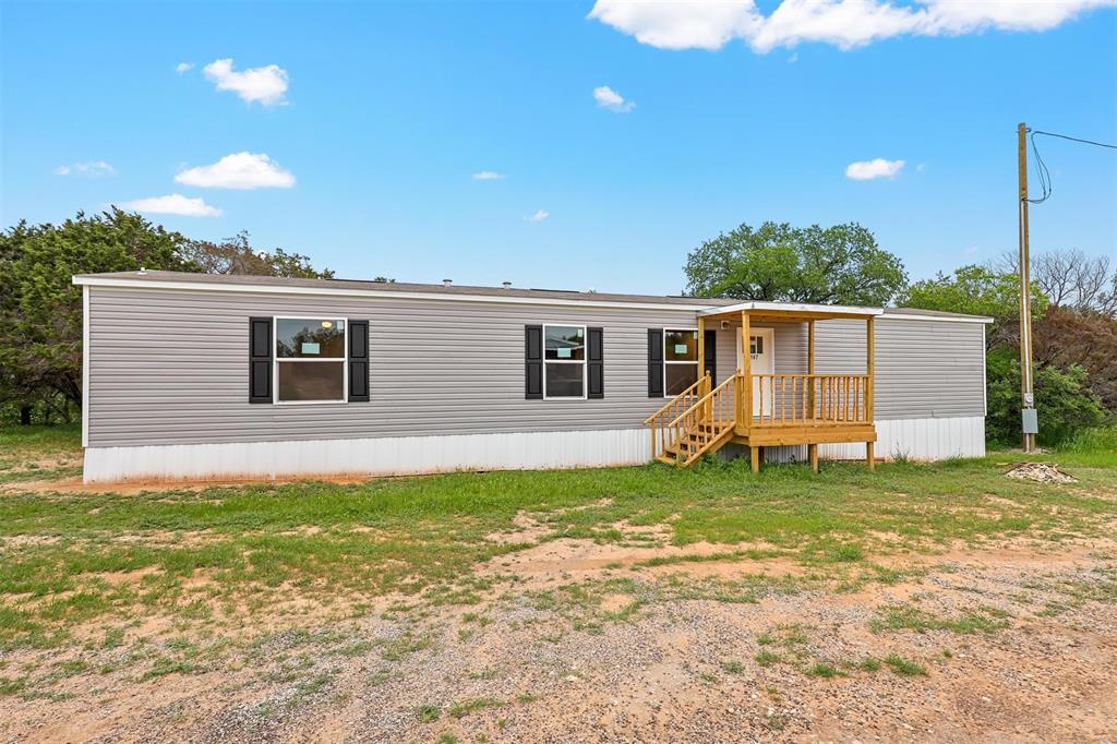 a view of a house with a backyard