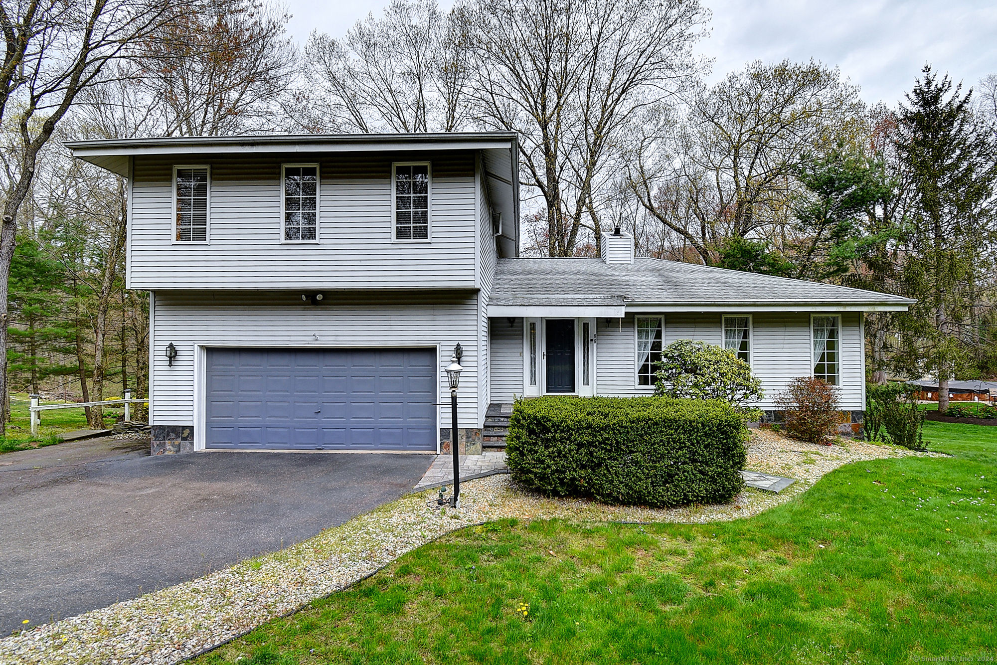 a front view of a house with a garden and yard