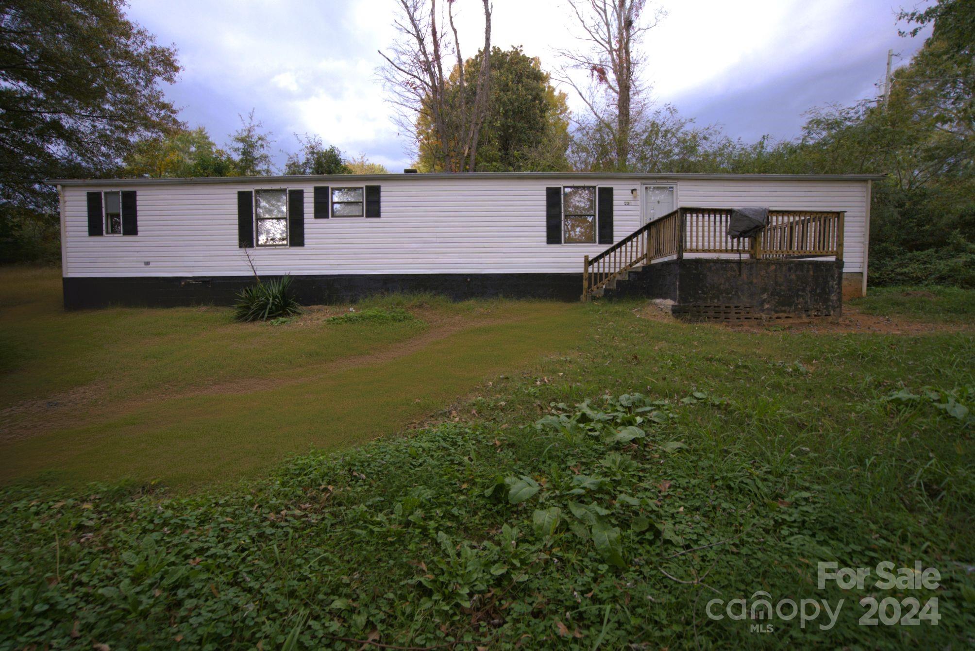 a view of house with outdoor space and swimming pool