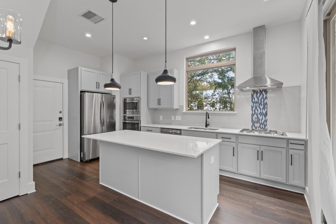 a large kitchen with stainless steel appliances kitchen island a large island in the center