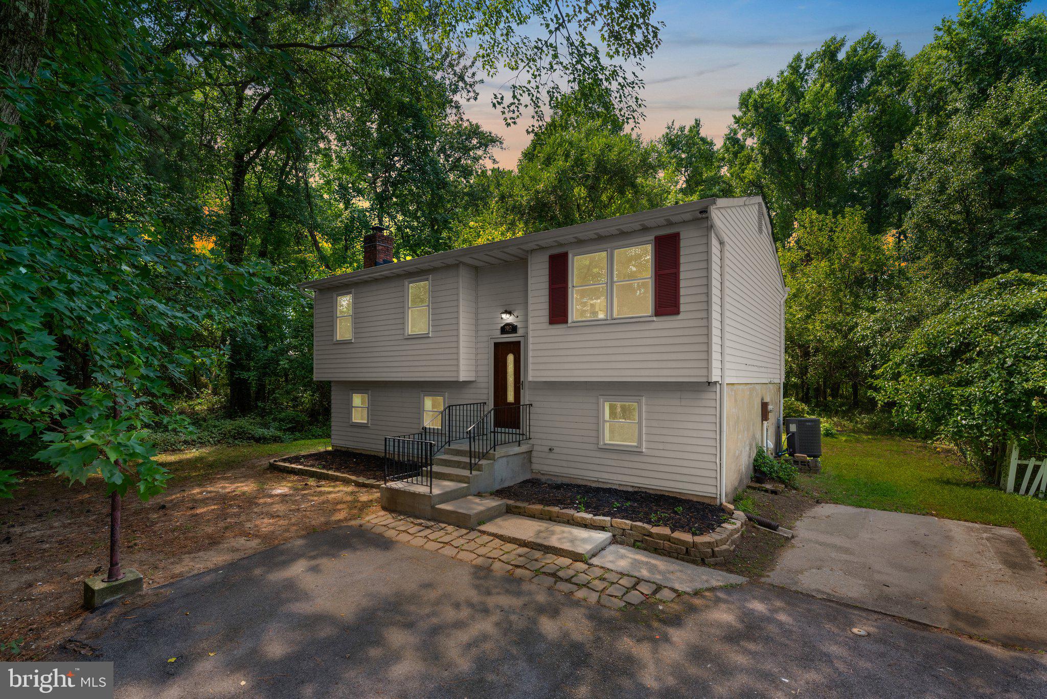 a front view of a house with a yard and a garage