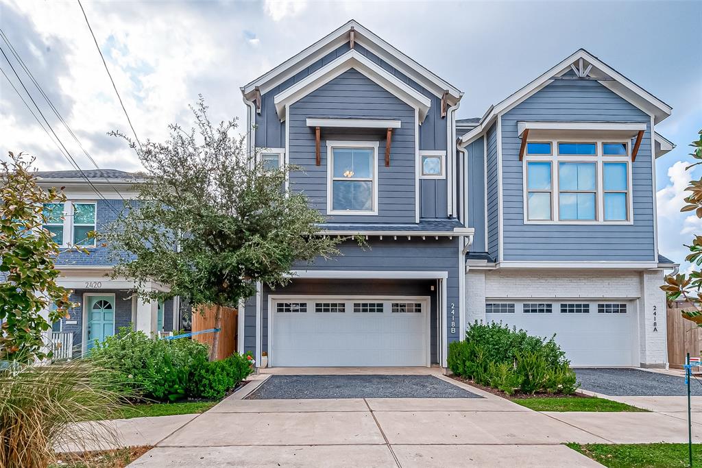 Gorgeous Modern three-story home with a light gray exterior, white trim, and large driveway. Lush manicured landscaping with drainage. Modern, yet traditional, with lots of stunning details.a two-car garage. Featuresspacious driveway andmanicured landscaping.