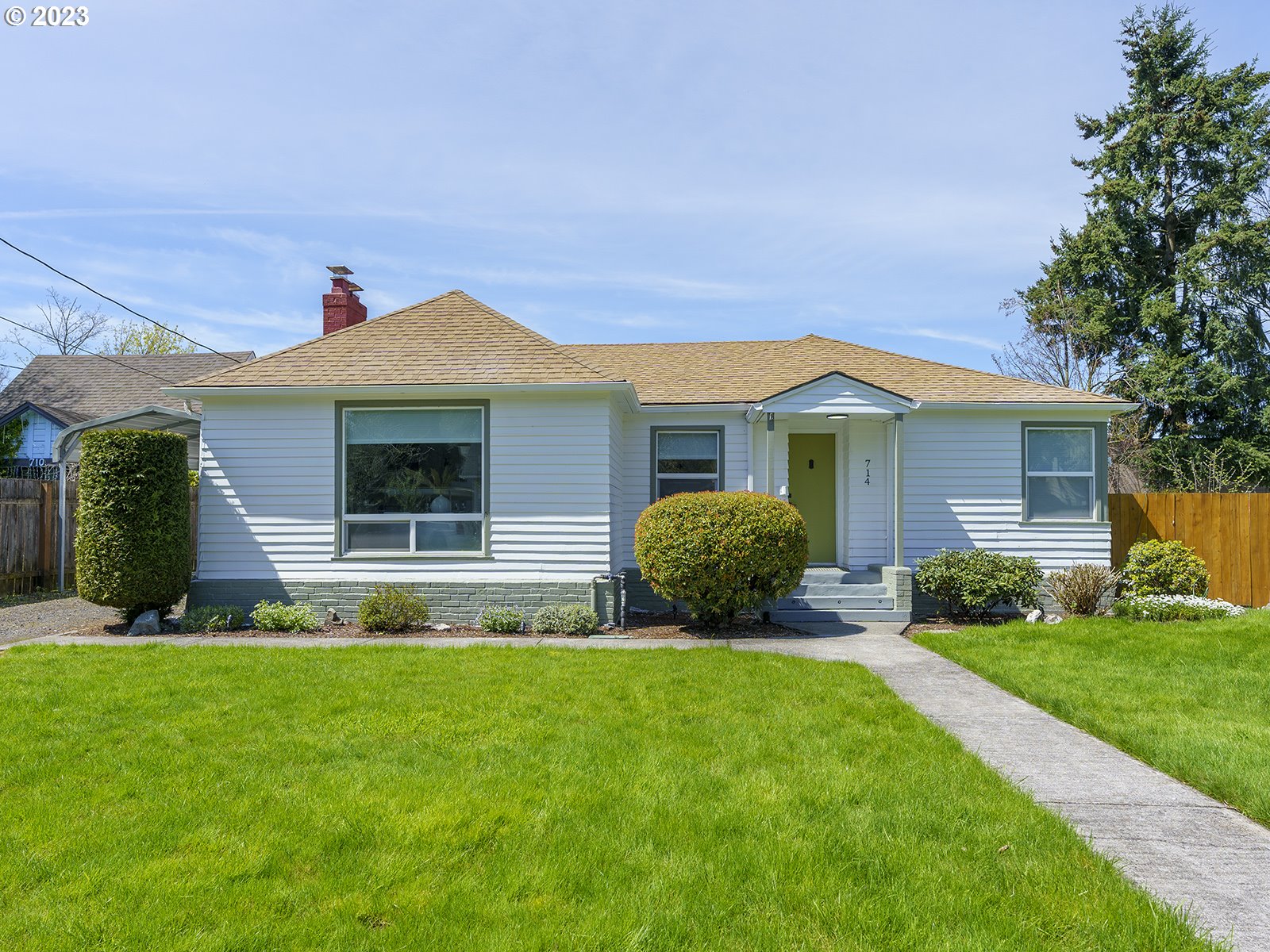 a front view of house with yard and green space