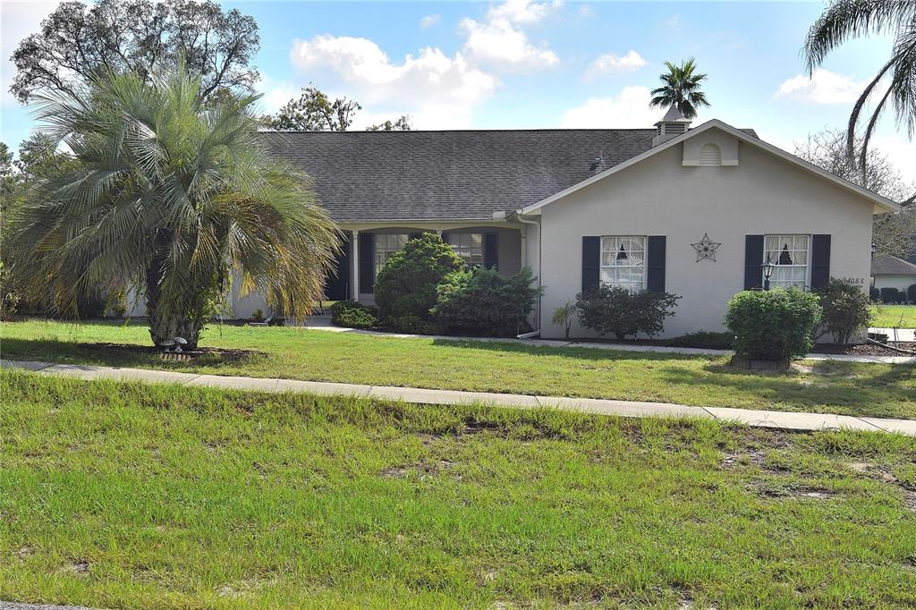 a front view of house with yard and green space