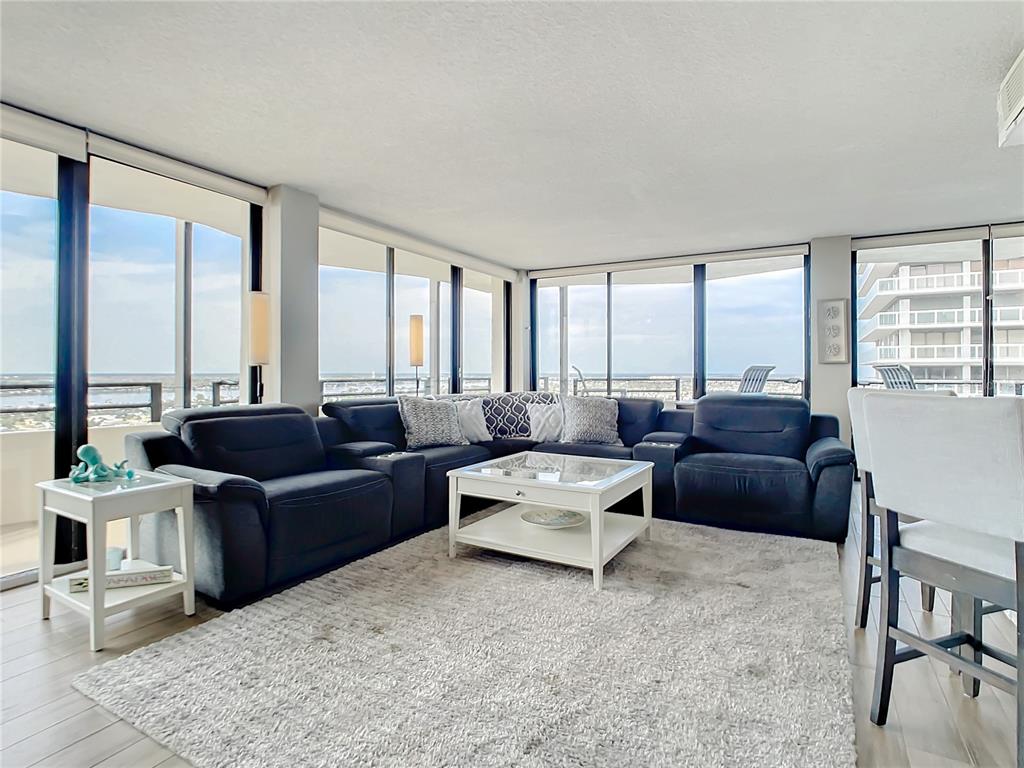 a living room with furniture and large windows