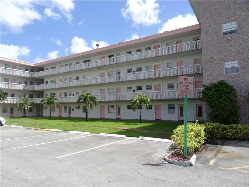 a large building with a garden in front of it