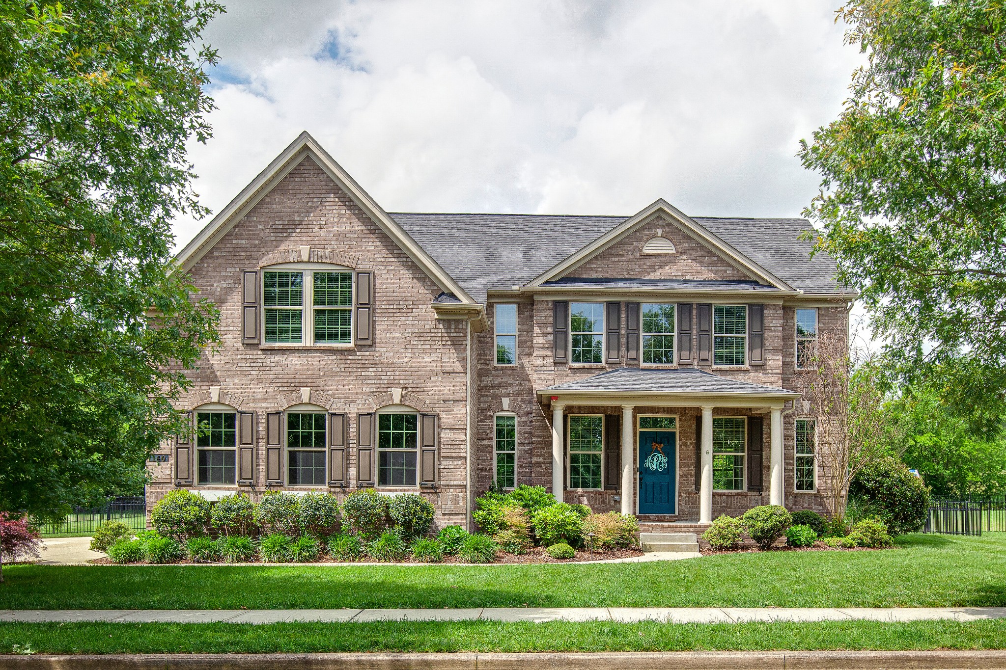 a front view of a house with a yard