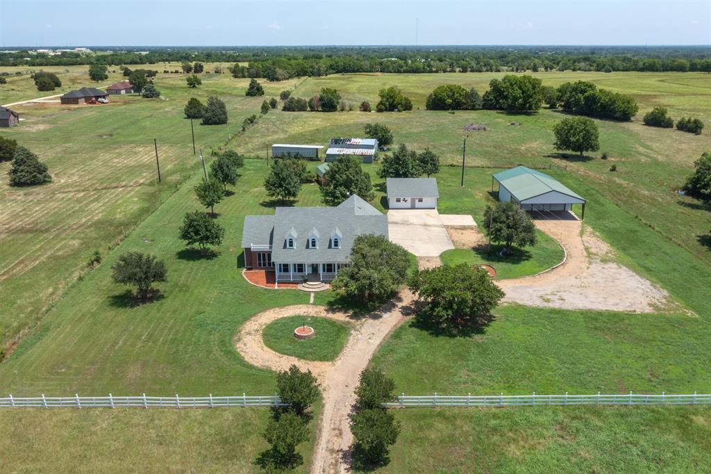 an aerial view of a house with a yard