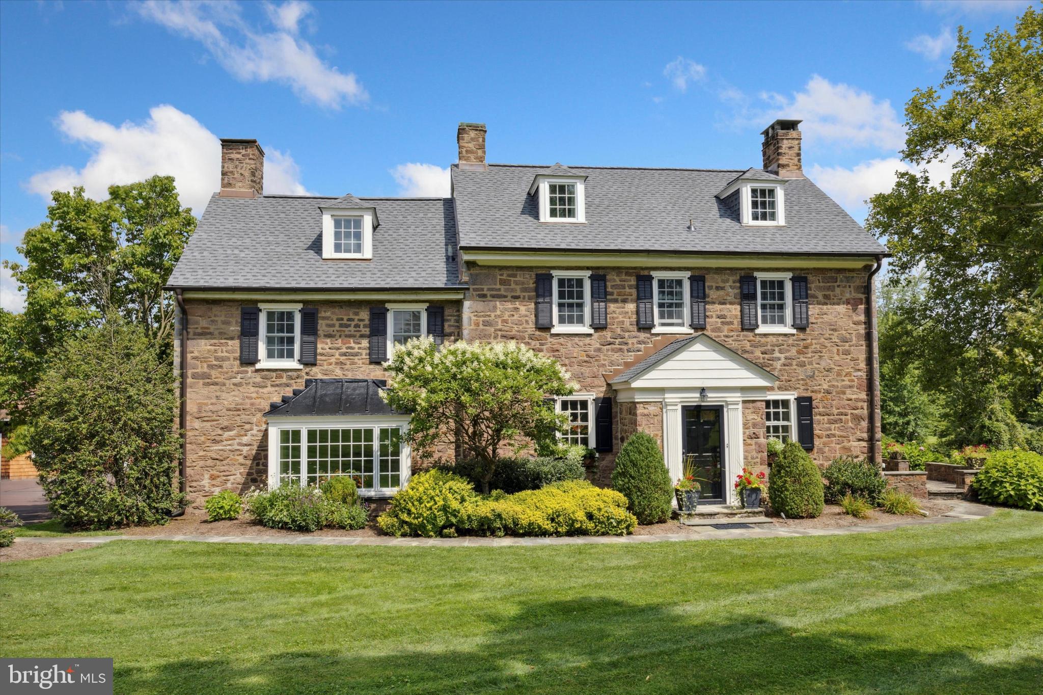 a front view of a house with a garden