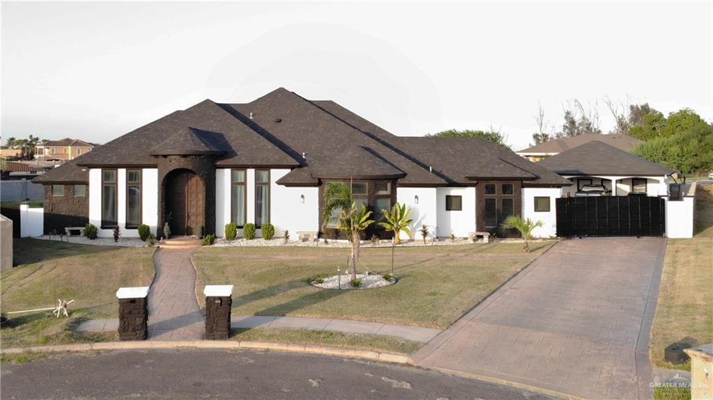 a view of a house with a yard and sitting area