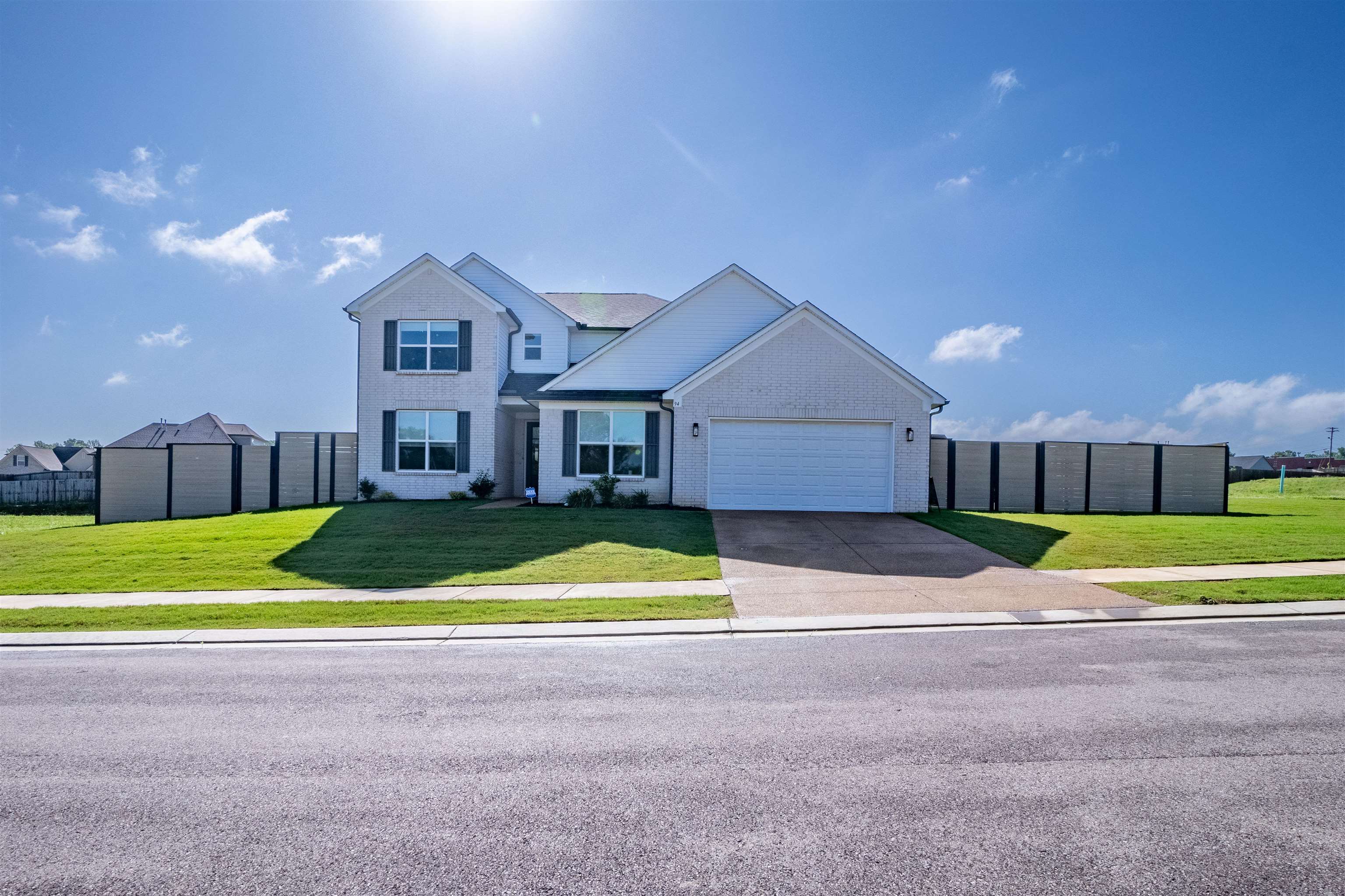 a view of an house with backyard and parking space