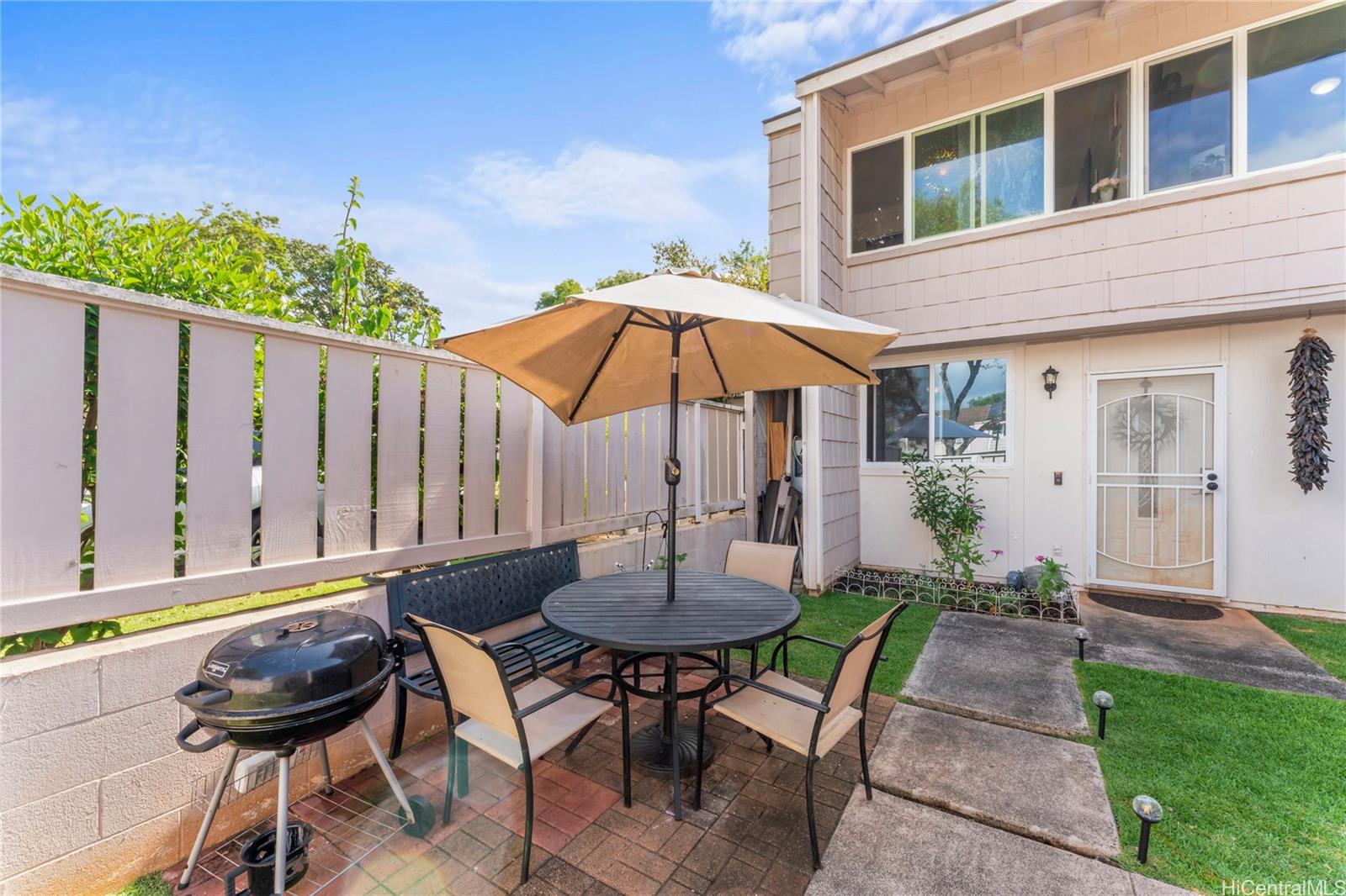 a view of a chairs and table in backyard