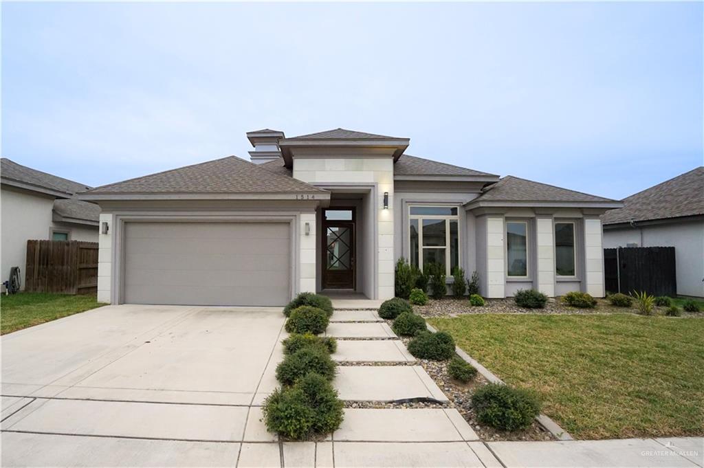 Prairie-style house featuring a front yard and a garage