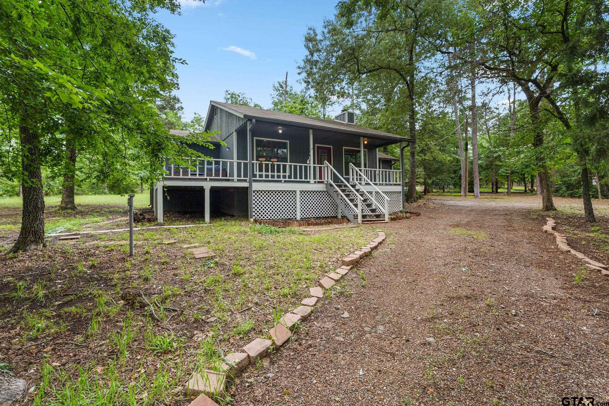 a house view with a sitting space and garden