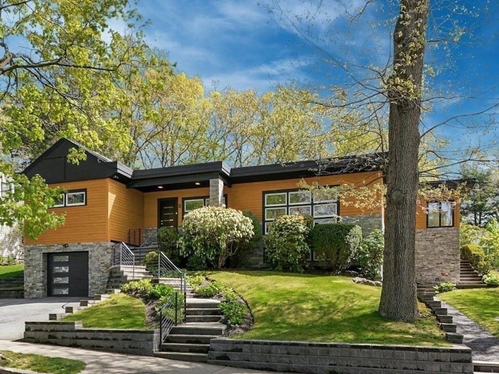 a front view of a house with garden