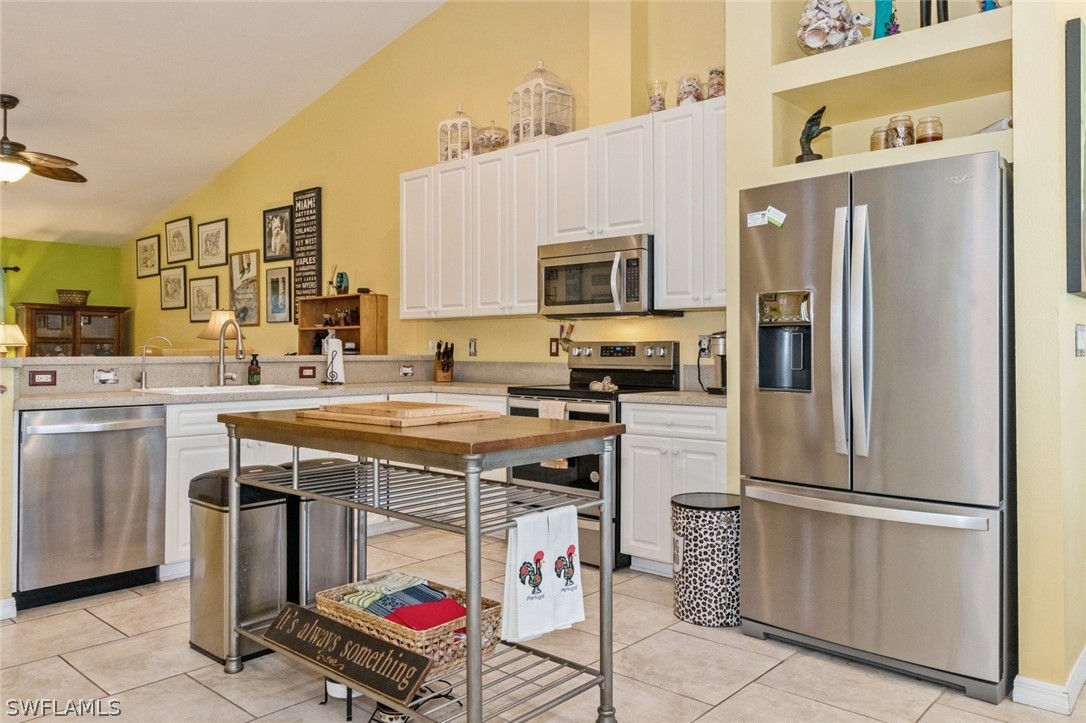 a kitchen with stainless steel appliances a stove refrigerator and a sink