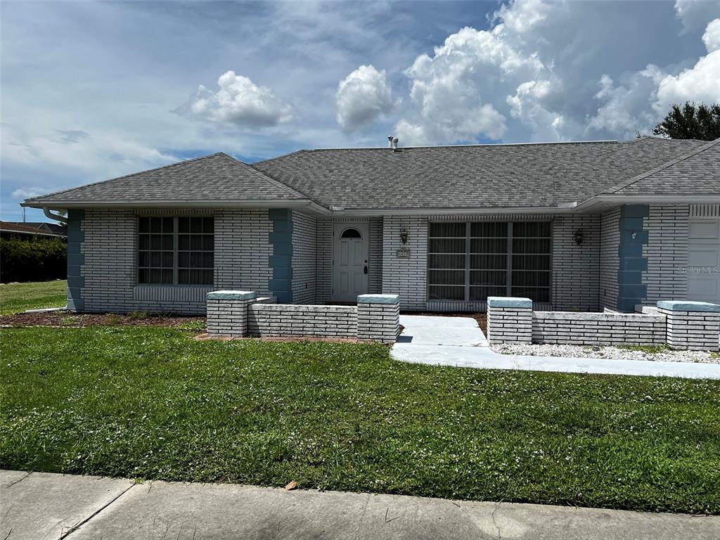 a view of a house with backyard porch and furniture