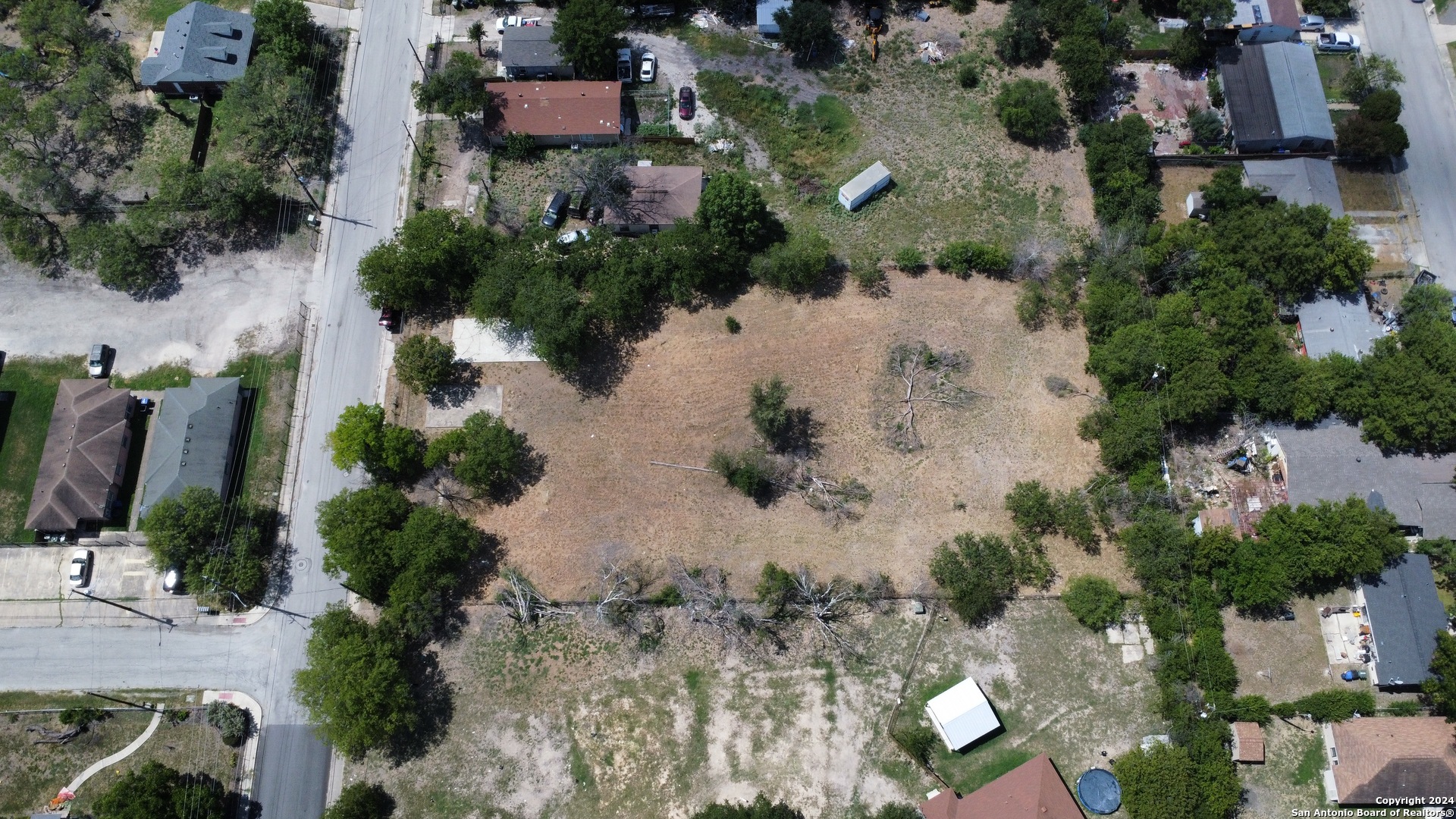 an aerial view of a house with a yard and lake view