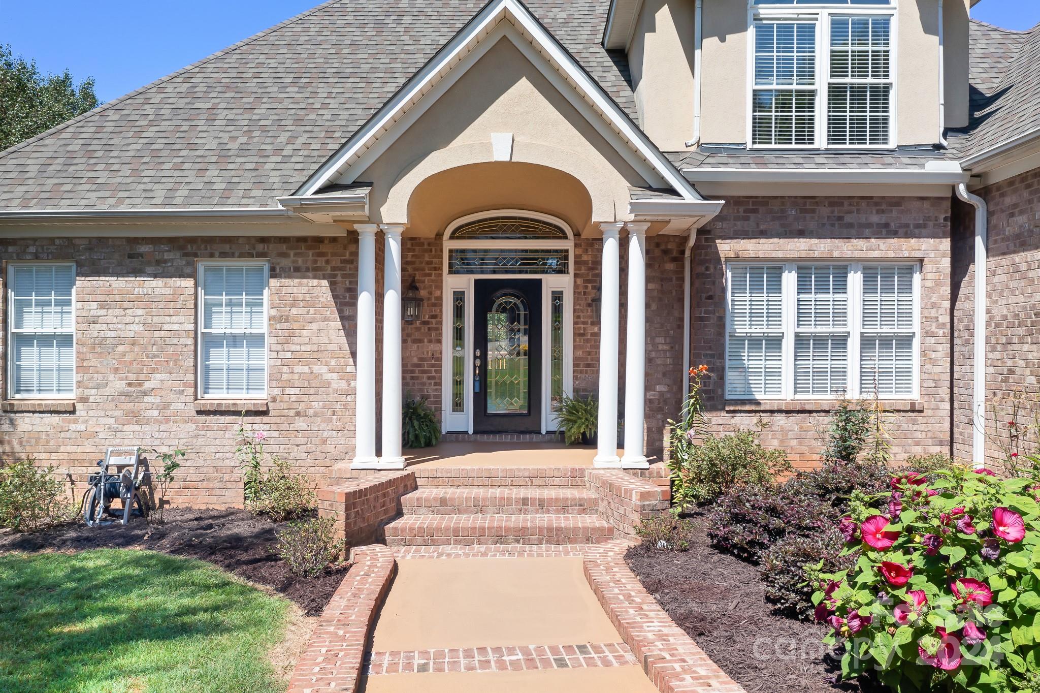 a view of a brick house with a large windows