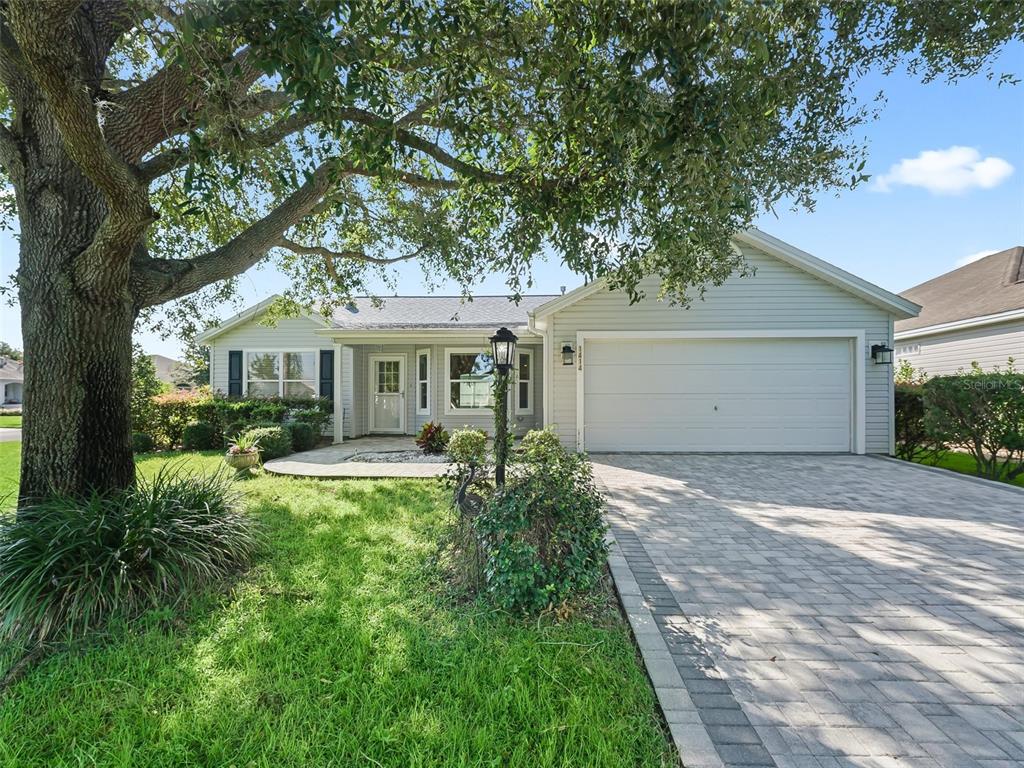 a front view of a house with yard and green space