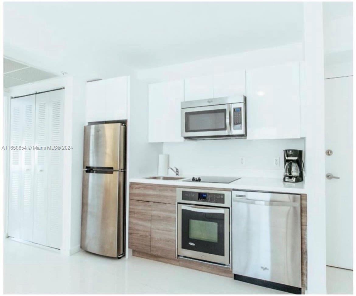 a kitchen with a stove microwave and refrigerator