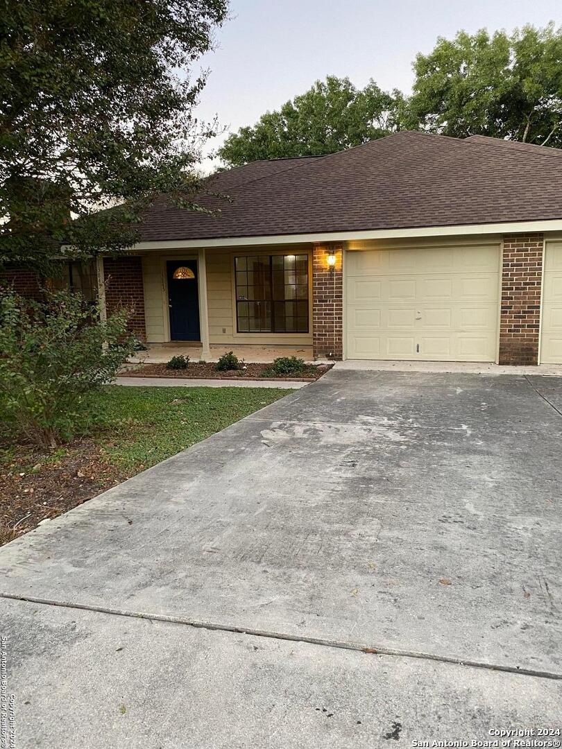 a front view of a house with a yard and a garage