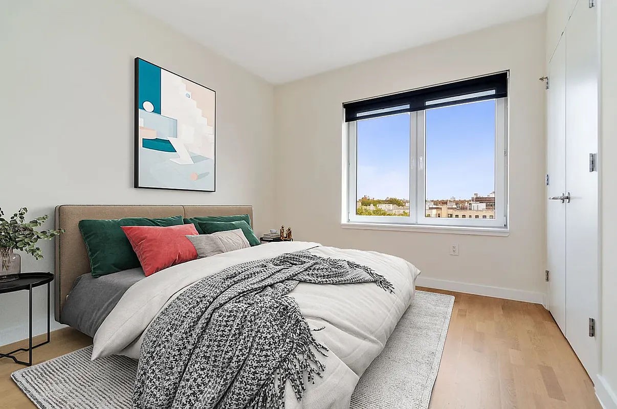 a bedroom with a bed and a painting on the wall