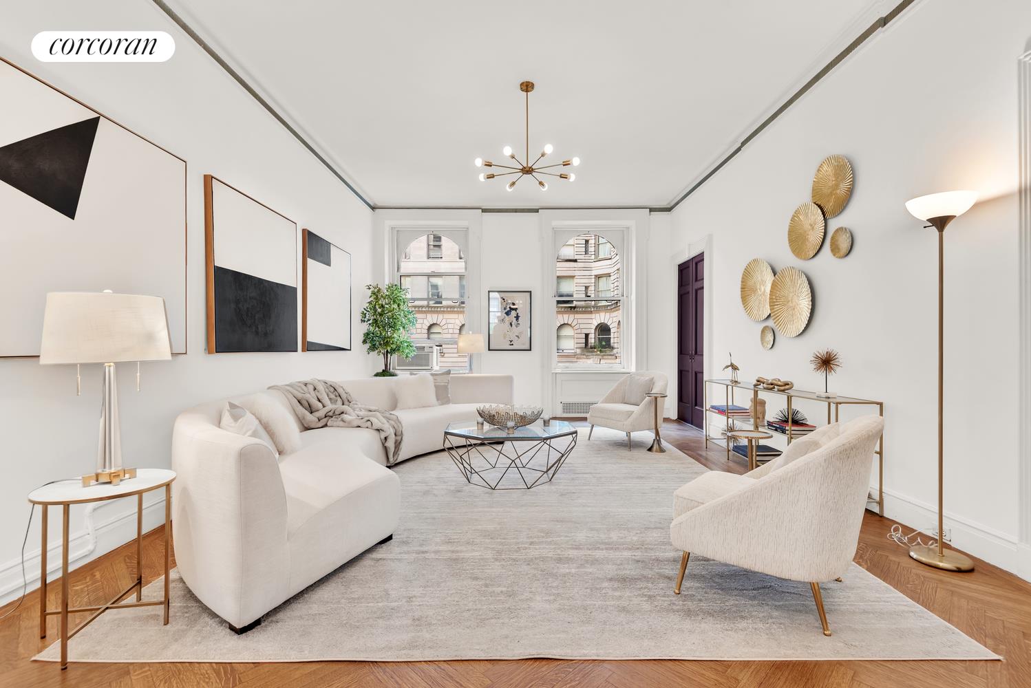 a living room with furniture chandelier and a flat screen tv