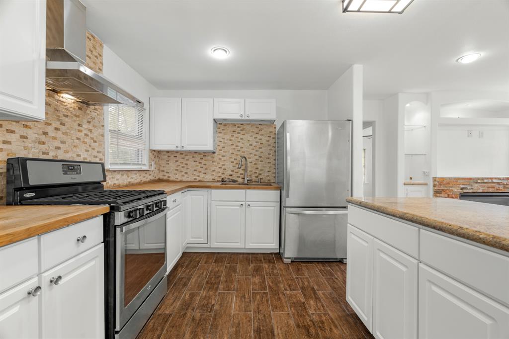 a kitchen with a sink stove and refrigerator