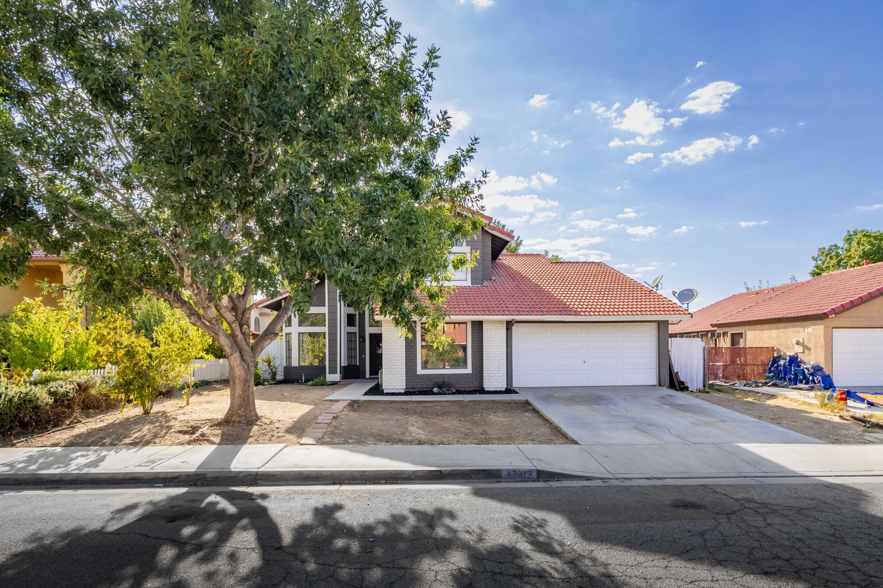 a large tree in front of a house