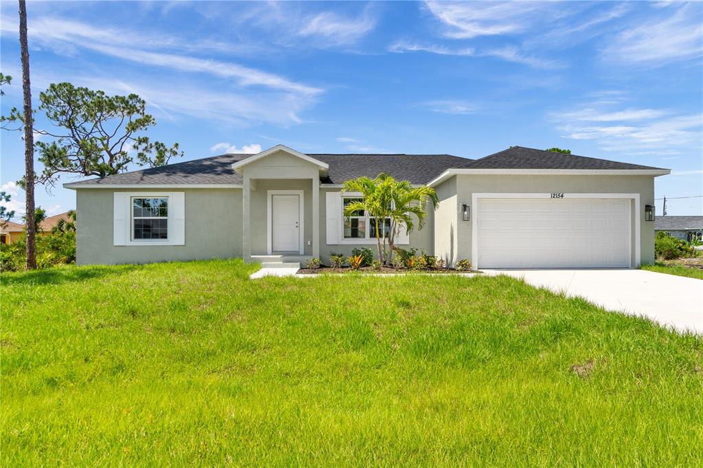 a front view of a house with a yard and garage