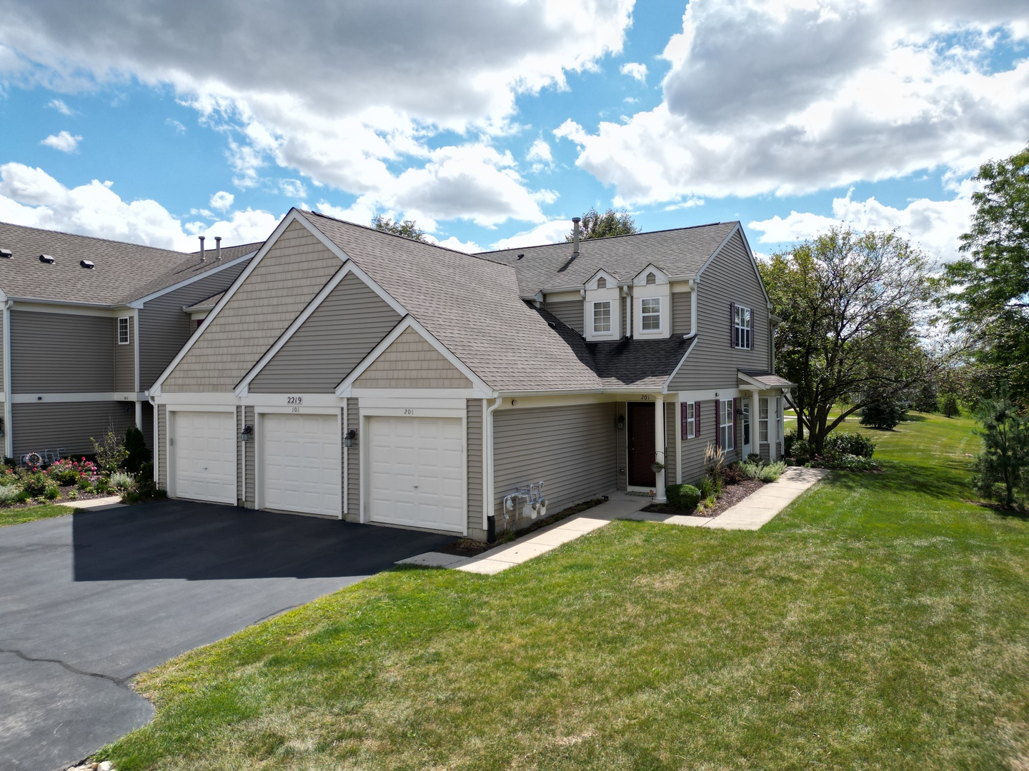 a front view of a house with a yard and garage