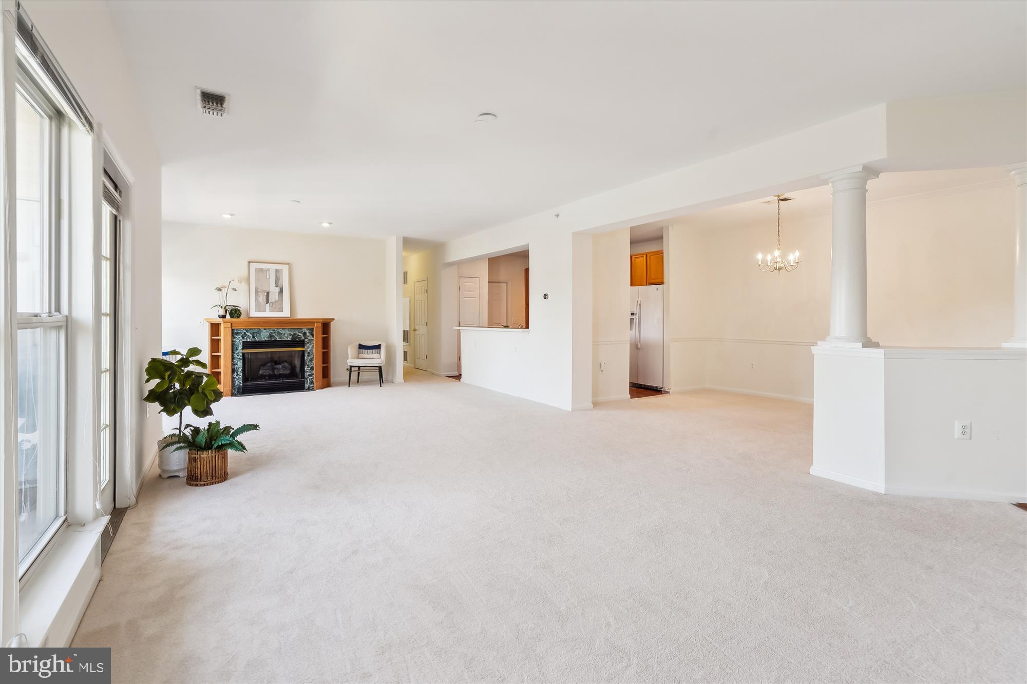 an empty room with furniture and a fireplace