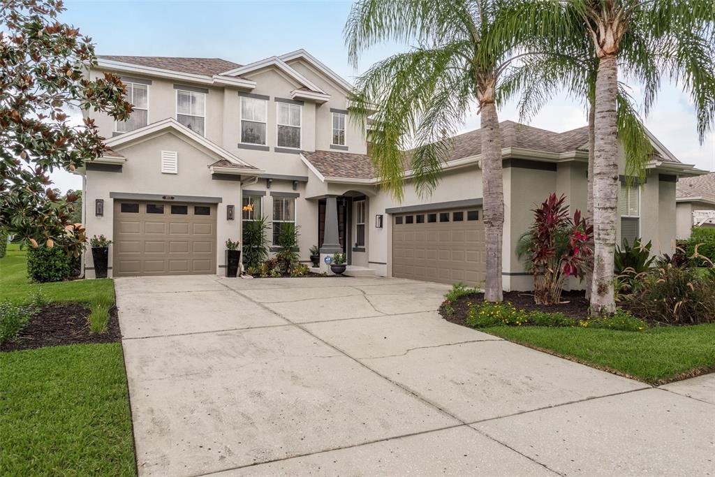 a front view of a house with a yard and a garage