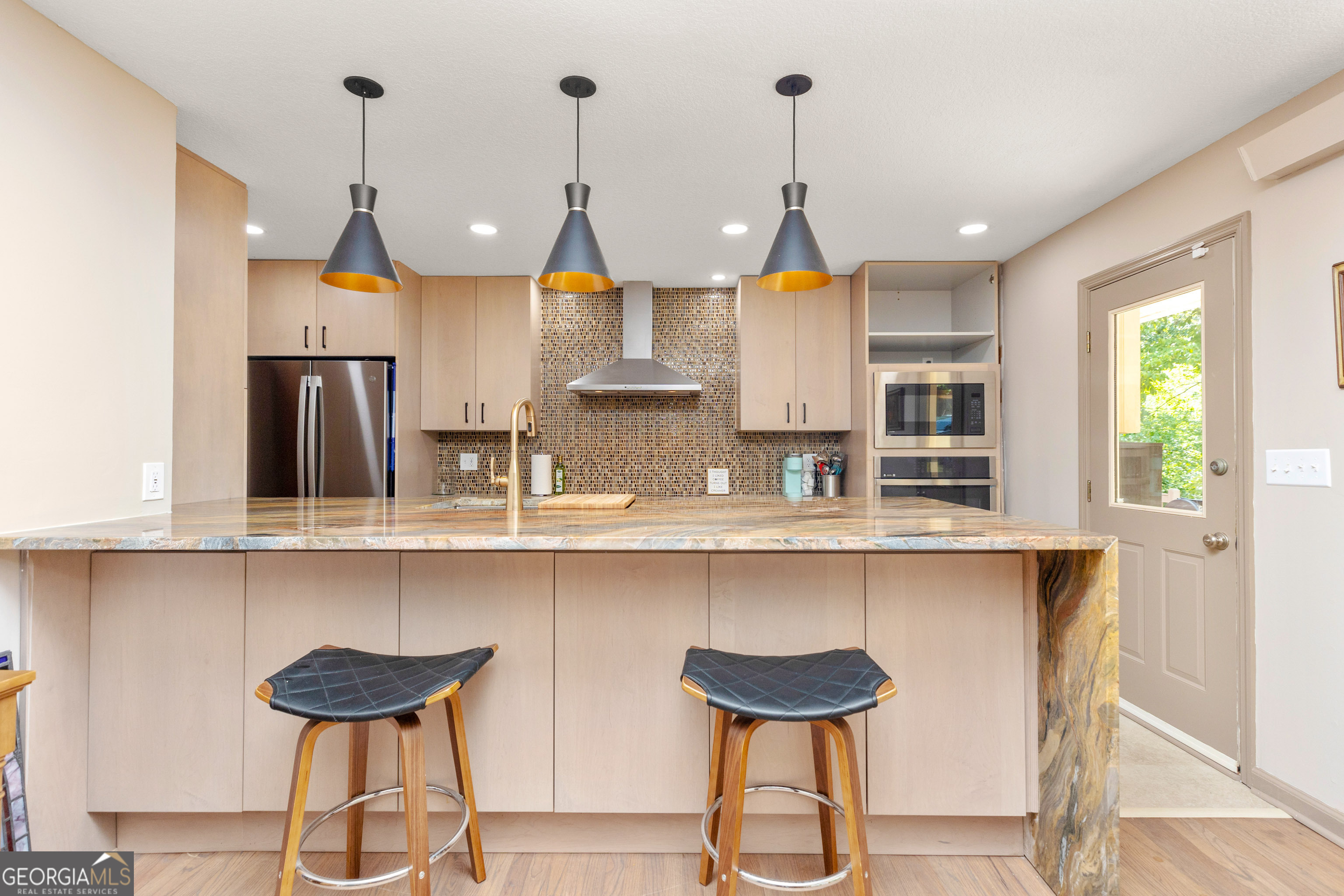 a kitchen with lots of counter space and windows