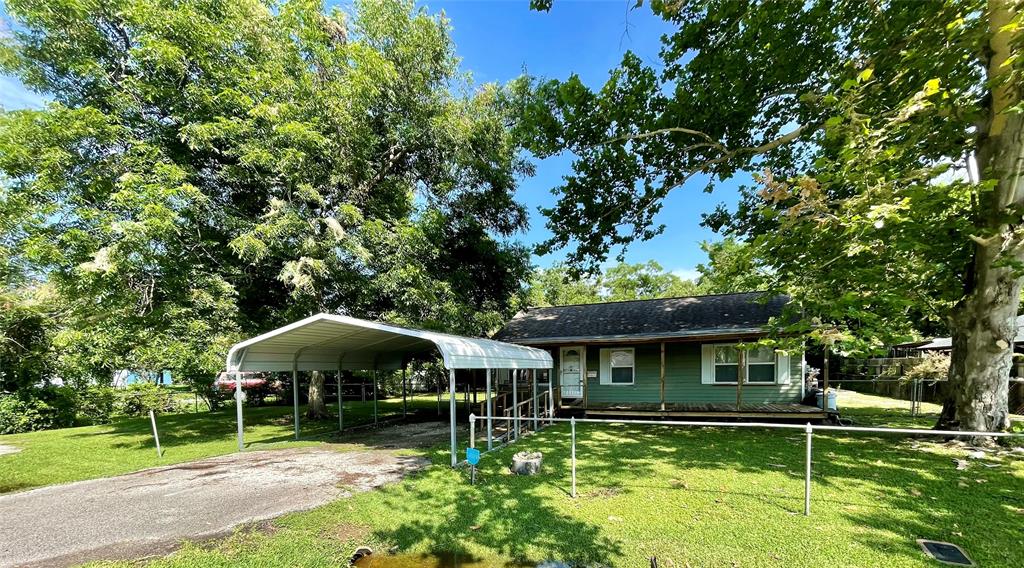 a view of a house with a yard from a patio