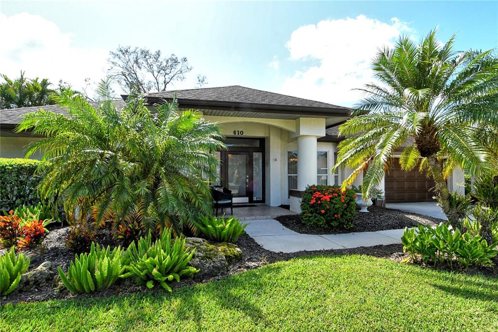 a front view of a house with a garden