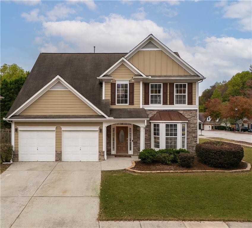 a front view of a house with a yard and garage