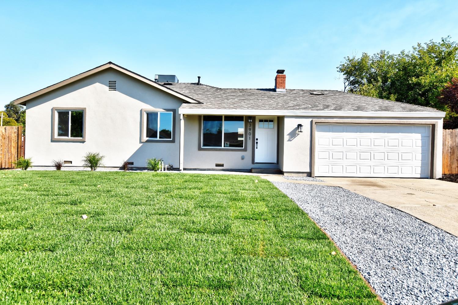 a front view of house with yard and green space