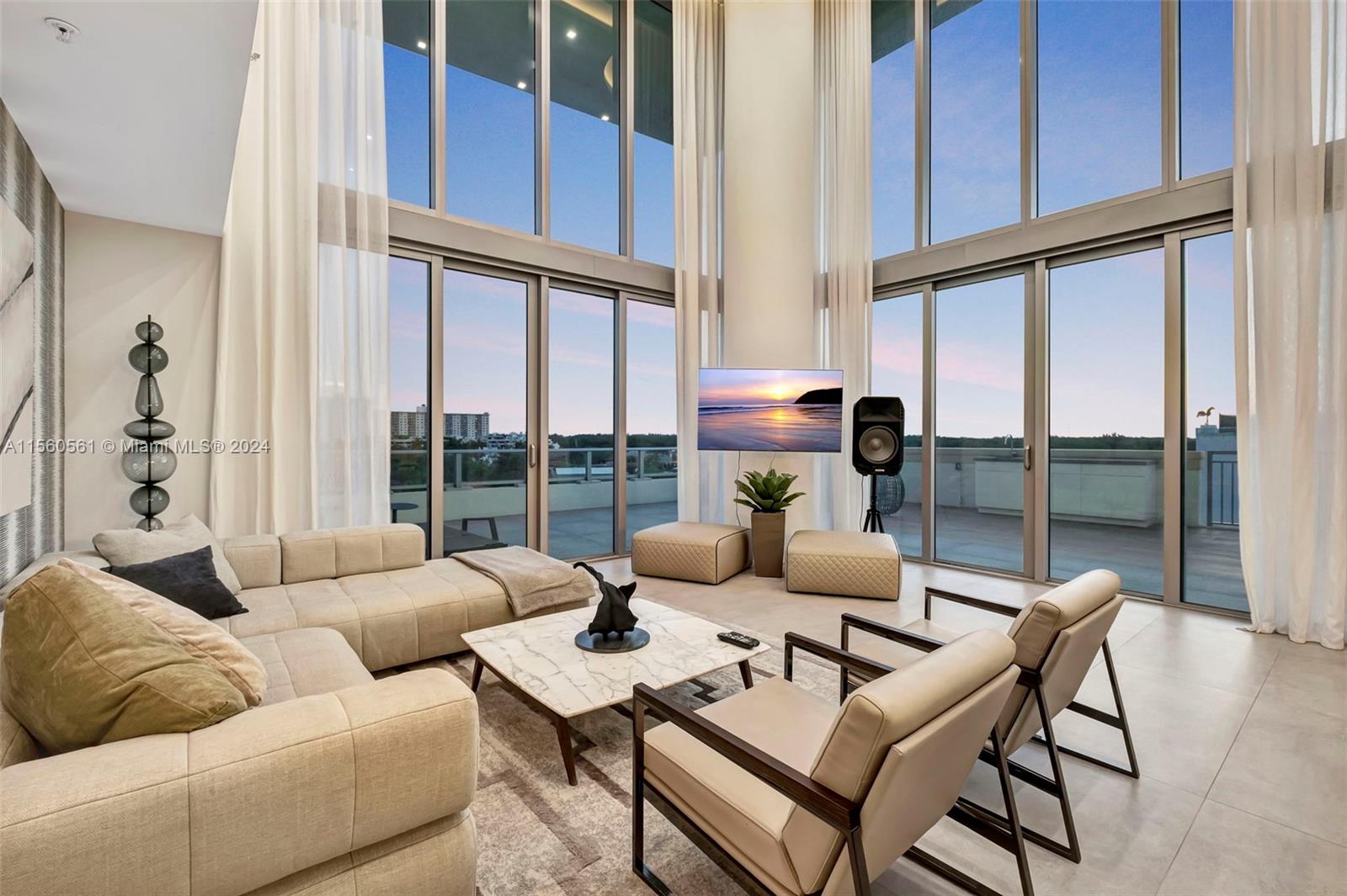 a living room with furniture windows and a table