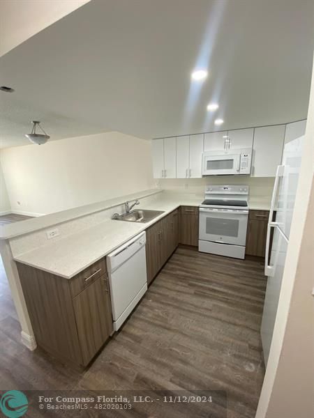 a kitchen with stainless steel appliances granite countertop a sink counter space and cabinets