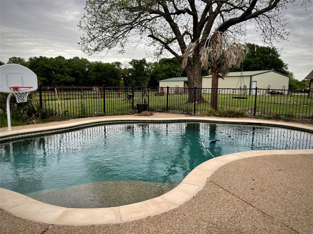 a view of a swimming pool with a patio