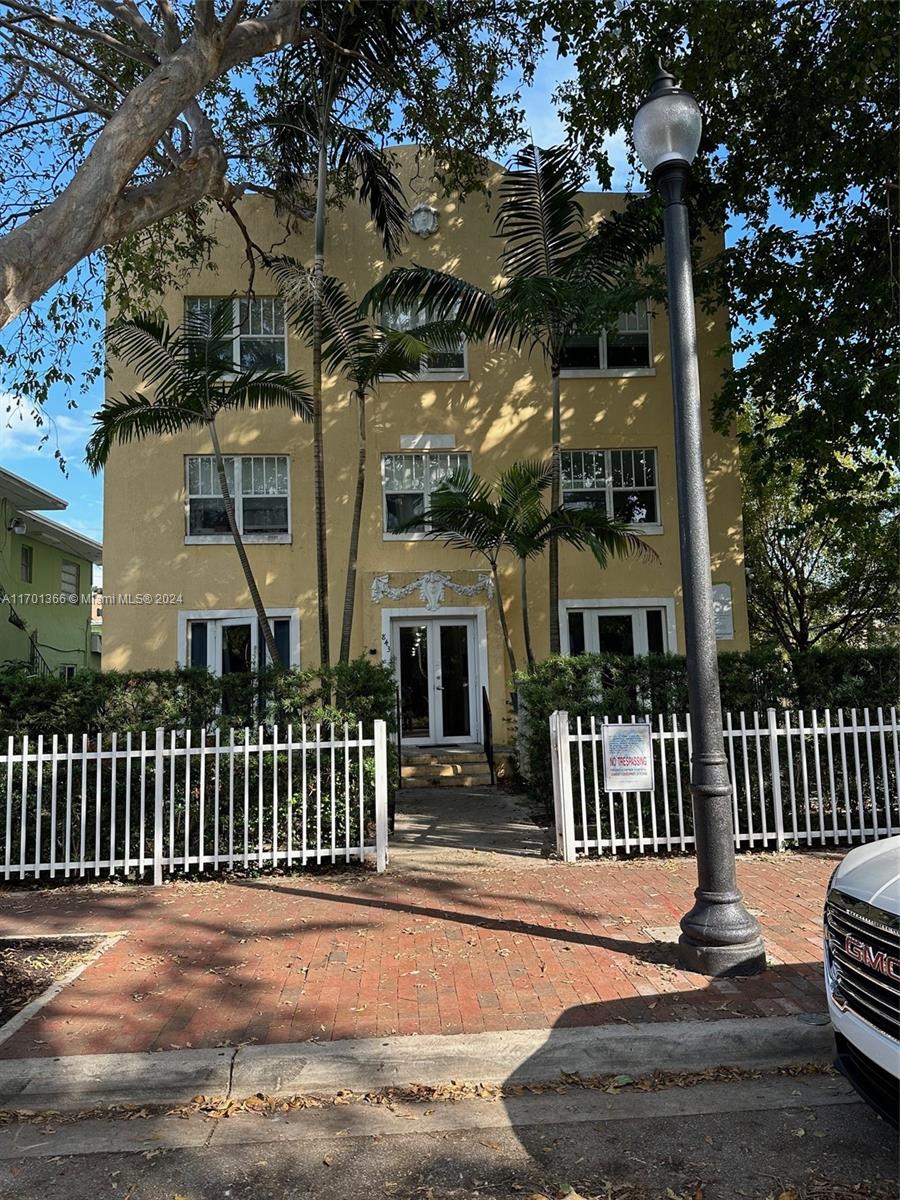 a front view of a house with a street