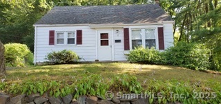 a front view of house and yard with green space