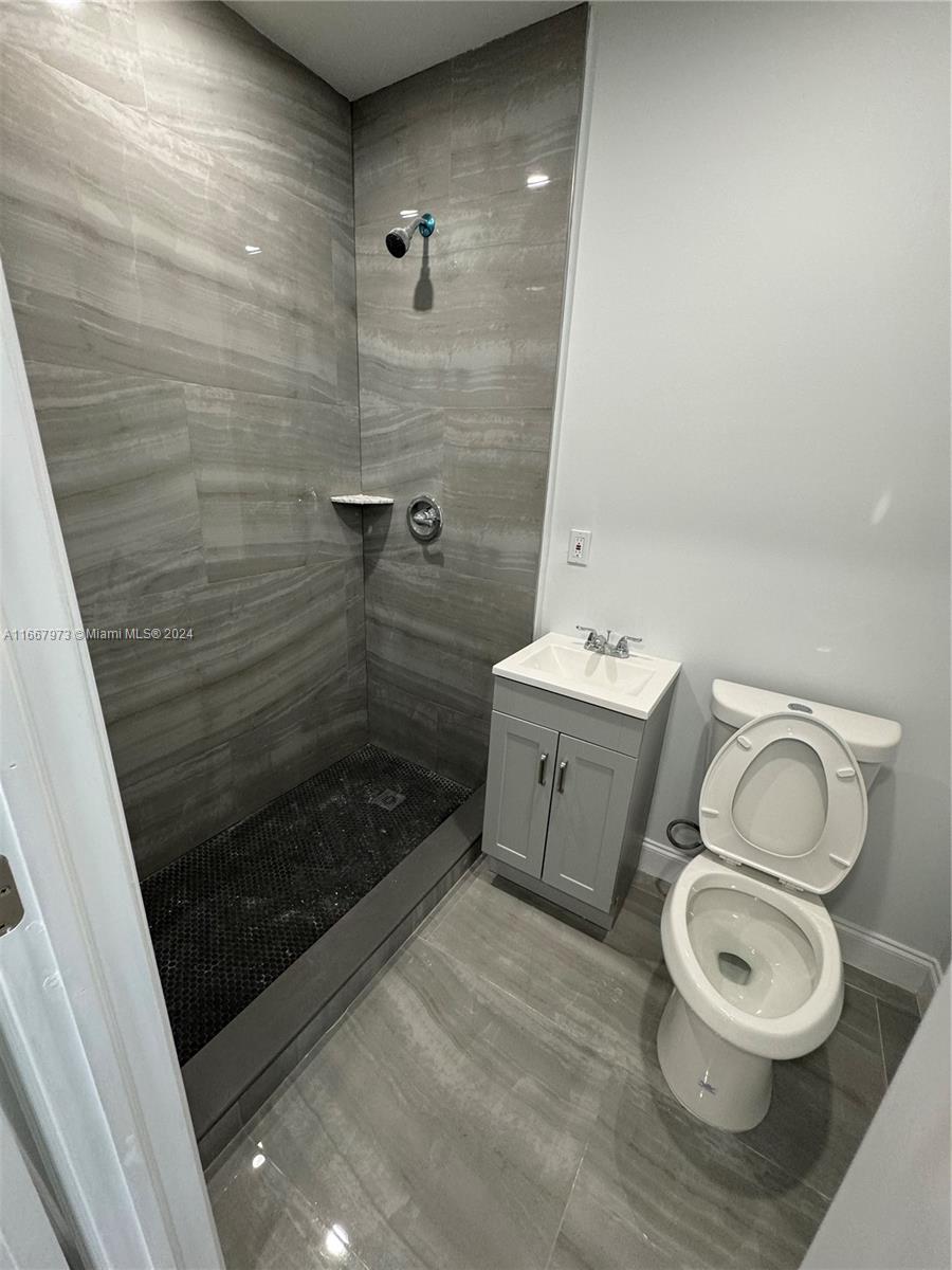 a bathroom with a toilet a sink and shower