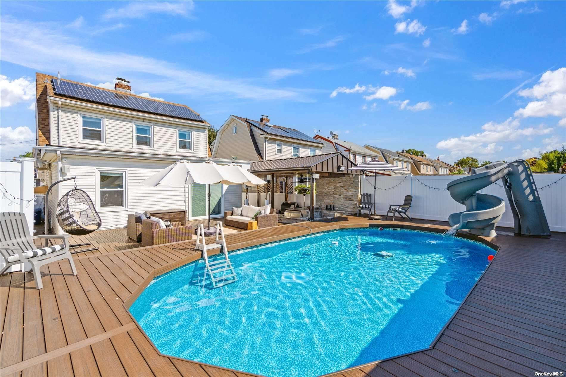 a view of a swimming pool with seating space