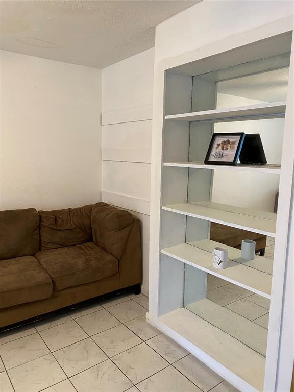 a living room with a couch and a cabinet