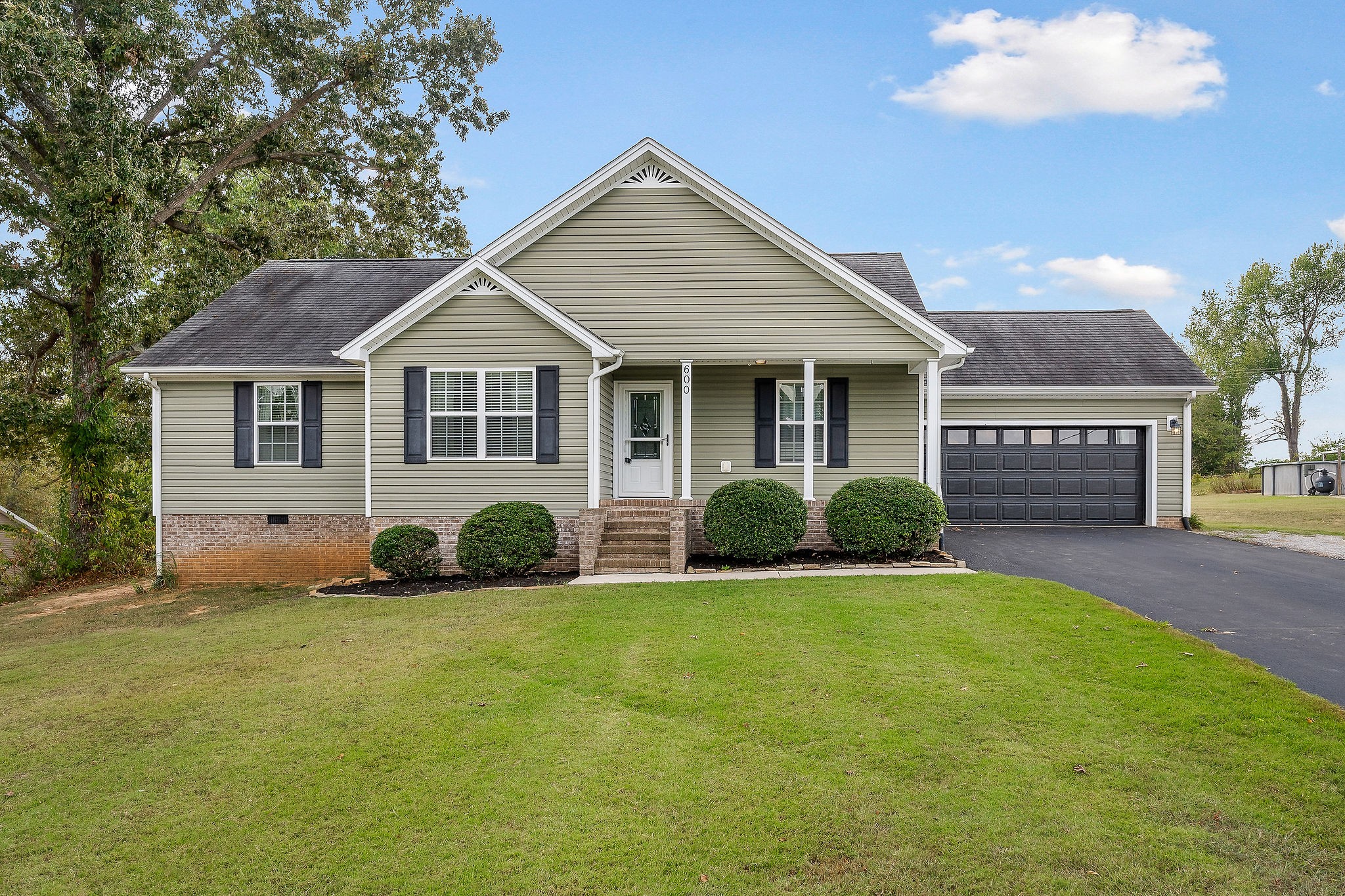 a view of a house with a yard and garage